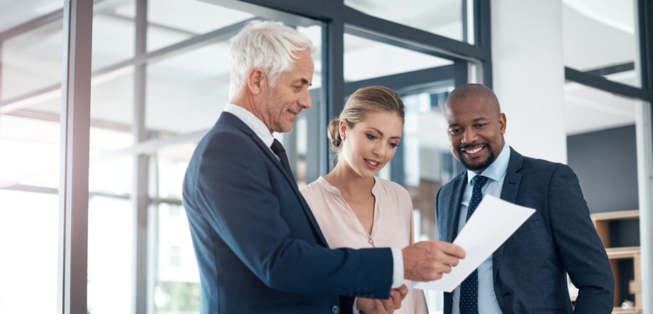 A financial advisor speaks to a man and woman.