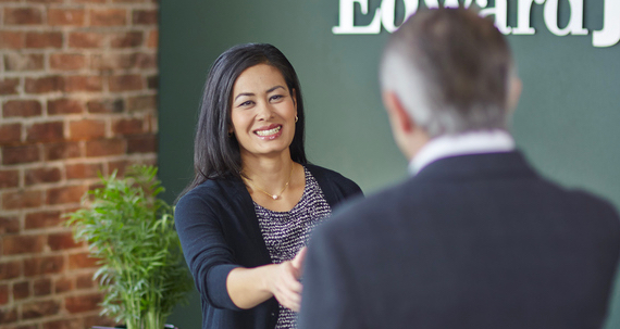 A woman shakes the hand of a man.