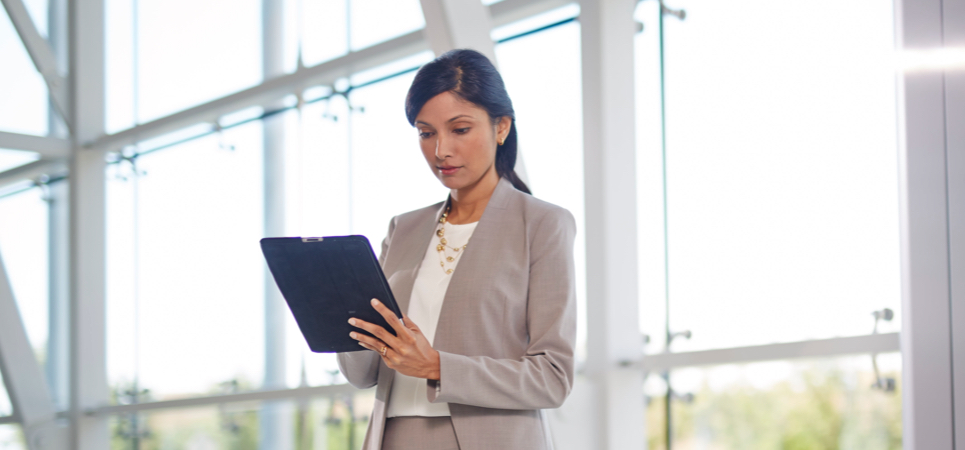 A business woman holding a tablet computer.