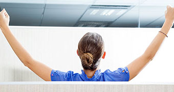 Woman stowing something in storage compartment